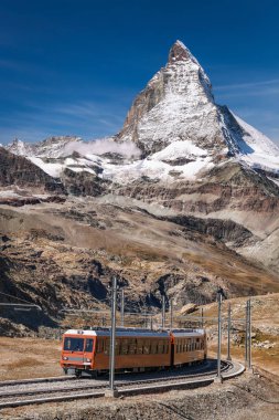 Famous Matterhorn peak with Gornergrat train in Zermatt area, Switzerland clipart