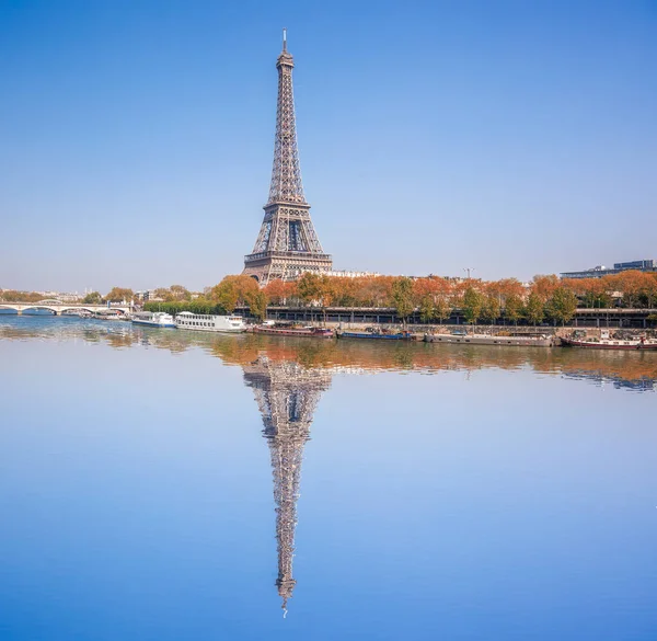 Eiffel Tower with autumn leaves in Paris, France