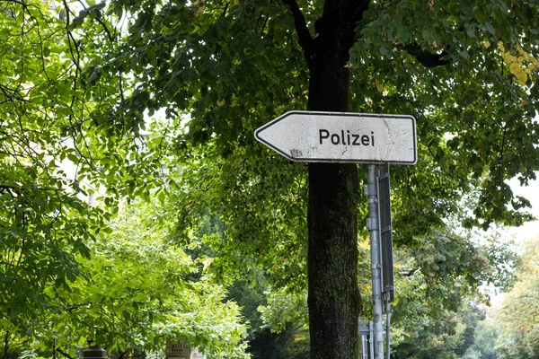 A dirty traffic sign show the direction to the police station (Polizei) in germany