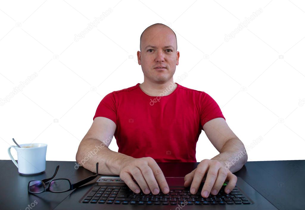 A male caucasian person at the notebook looking to the webcam - white background