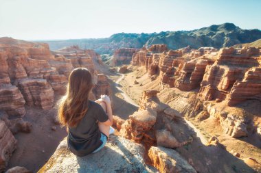 Girl Watching over Charyn Canyon in South East Kazakhstan taken in August 2018 taken in hdr clipart