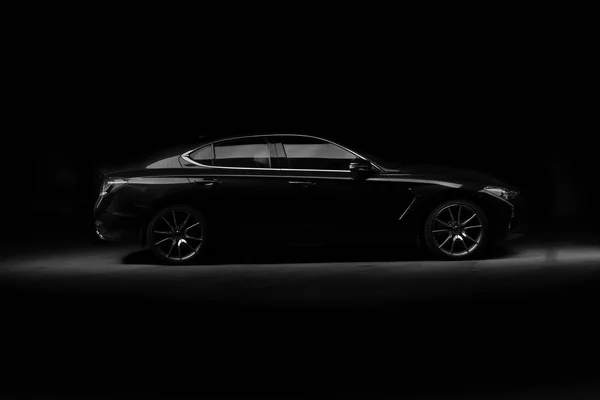 Silhouette of black sports car with headlights on black background — Stock Photo, Image