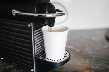 Siyah kahve makinesi fincan içine espresso dökme. 