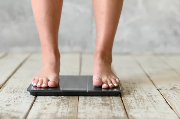 Girl standing on scales. Body positive. Size plus
