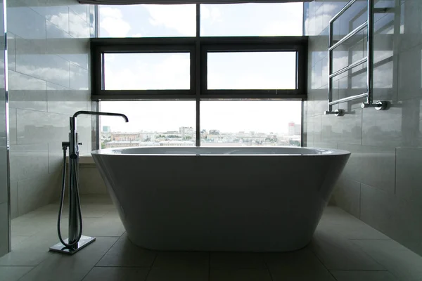 luxury bathroom with city view. Interior of modern luxury minimalistic bathroom with window