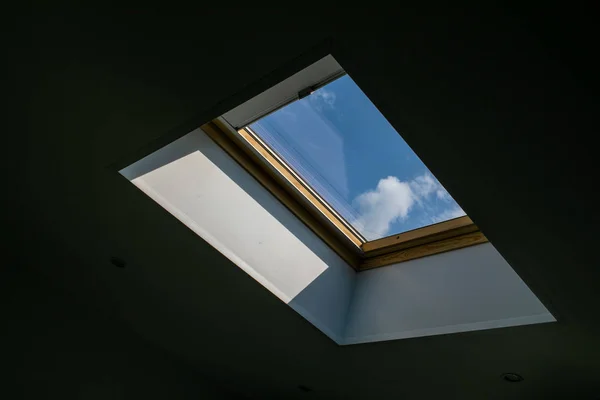 Felnéz a kék felhős égre a modern négyzet alakú mennyezeti ablakon keresztül. — Stock Fotó