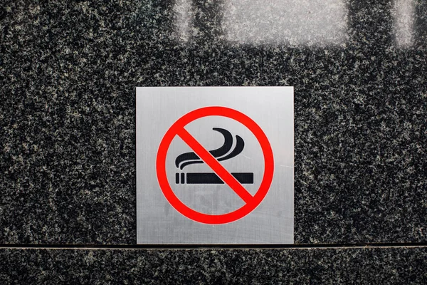 no smoking sign. The sign does not smoke on the wall.