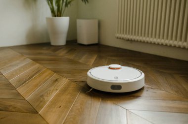 robotic vacuum cleaner on laminate wood floor smart cleaning technology clipart