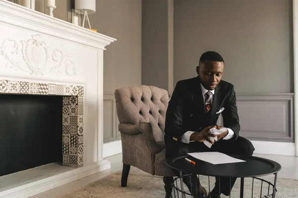 Jovem empresário afro-americano em terno de negócios tomando notas — Fotografia de Stock