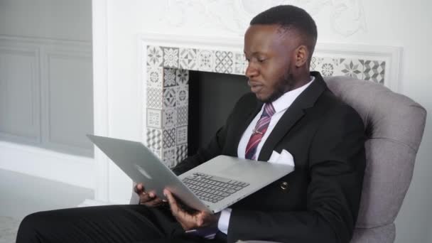 Young successful african businessman celebrate victory look at laptop winning lottery or contract bid using computer got prize feel good surprise about new job opportunity read great online news — Stock Video