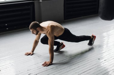 Siyah şort giyen bir sporcu şınav çekiyor. egzersiz