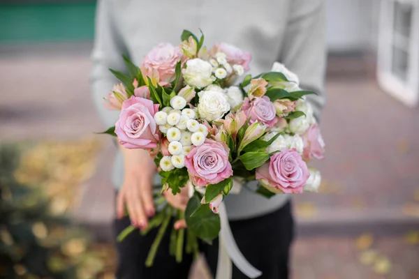 Handsome fresh bouquet. Flowers delivery. Woman florist. Beautiful bouquet of mixed flowers. Floral shop concept