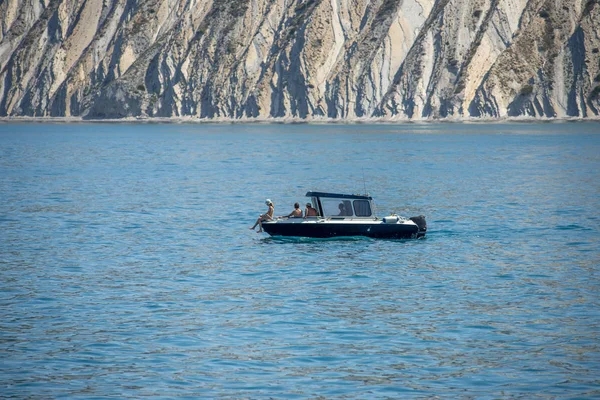 Anapa, Ryssland-17 juni 2019: familj på en motorbåt på sommaren på en klar solig dag. Båt i havet mot klipporna — Stockfoto