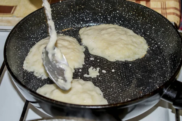 Making pancakes on a cast-iron frying pan Belarus