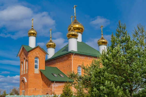 Rode baksteen christelijke kerk met gouden koepels — Stockfoto