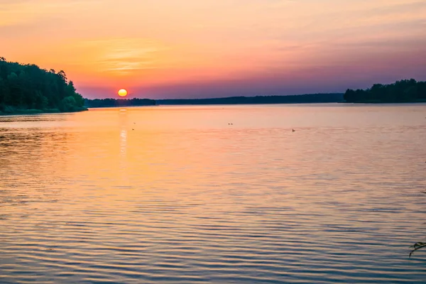 Napfelkeltét a nyári tó egy erdős területen — Stock Fotó