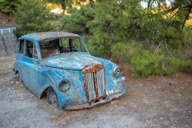 old car next to the road in Greece clipart
