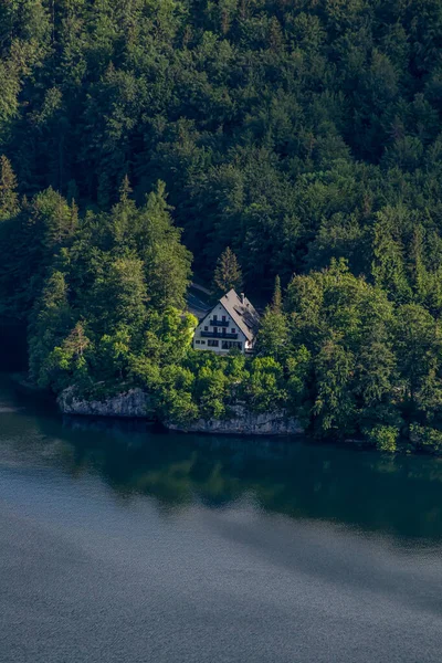 Building on rock next to lake