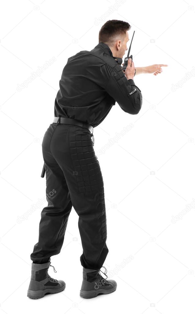 Male security guard using portable radio transmitter on white background