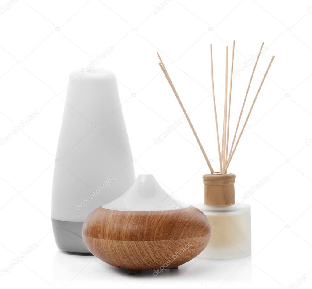 Different aroma oil diffusers on white background. Air freshening
