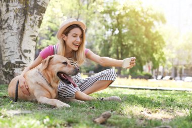 Genç kadın selfie köpeğini ile açık havada alarak. Evde beslenen hayvan kaygı