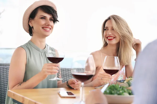 Group of friends with glasses of wine at table
