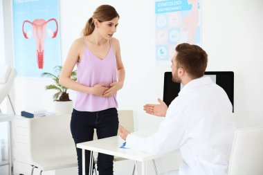 Gynecology consultation. Woman with her doctor in clinic clipart