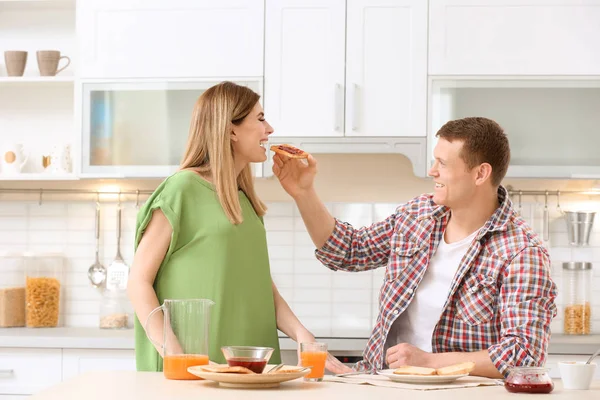 Kahvaltı Lezzetli Kızarmış Ekmek Ile Mutfak Masasında Mutlu Güzel Çift — Stok fotoğraf