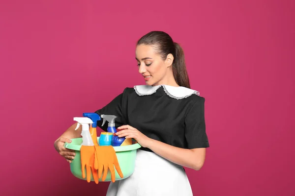 Jovem Camareira Segurando Bacia Plástico Com Detergentes Sobre Fundo Cor — Fotografia de Stock