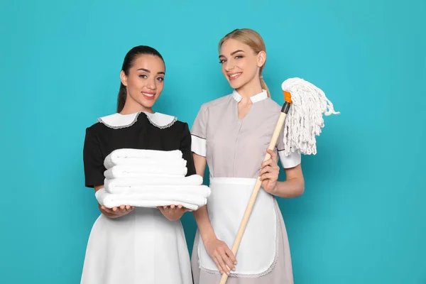 Young Chambermaids Stack Clean Towels Mop Color Background — Stock Photo, Image