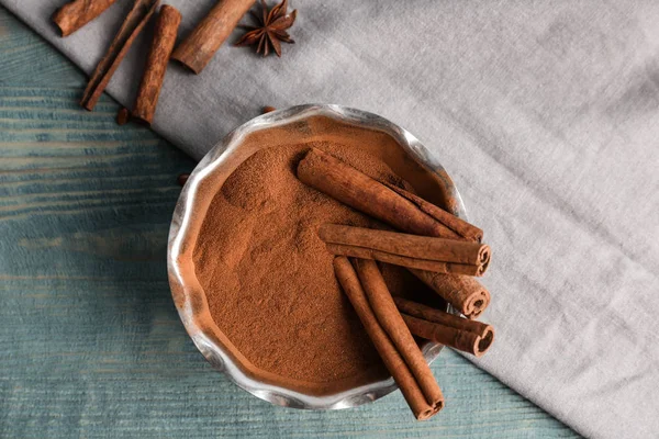 Bowl Aromatic Cinnamon Powder Sticks Wooden Background — Stock Photo, Image