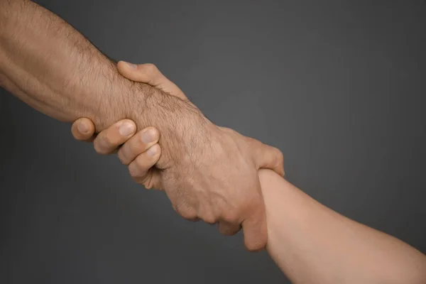 Men Holding Hands Together Grey Background Unity Concept — Stock Photo, Image