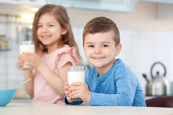 かわいい子供たちが台所で牛乳を飲んで — ストック写真