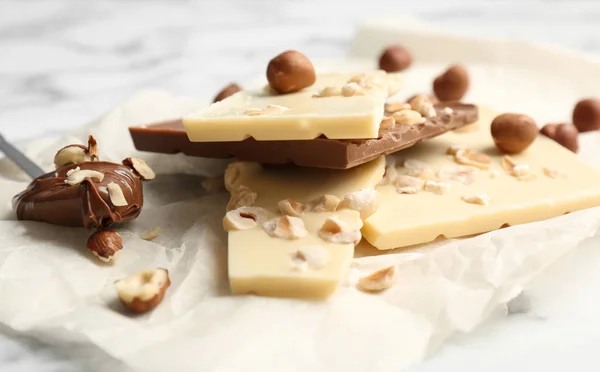 Delicious milk and white chocolate bars on table