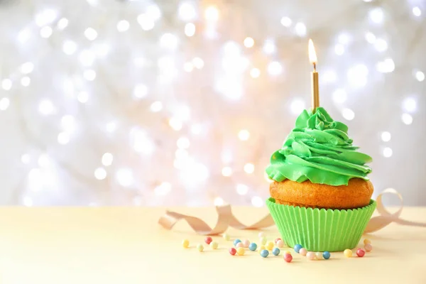 Cupcake with sparkling candle for 39th birthday or anniversary with big  number in white with yellow streamers on blue table with dark background  full Stock Photo - Alamy