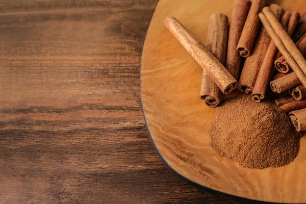 Plate Aromatic Cinnamon Powder Sticks Wooden Table — Stock Photo, Image