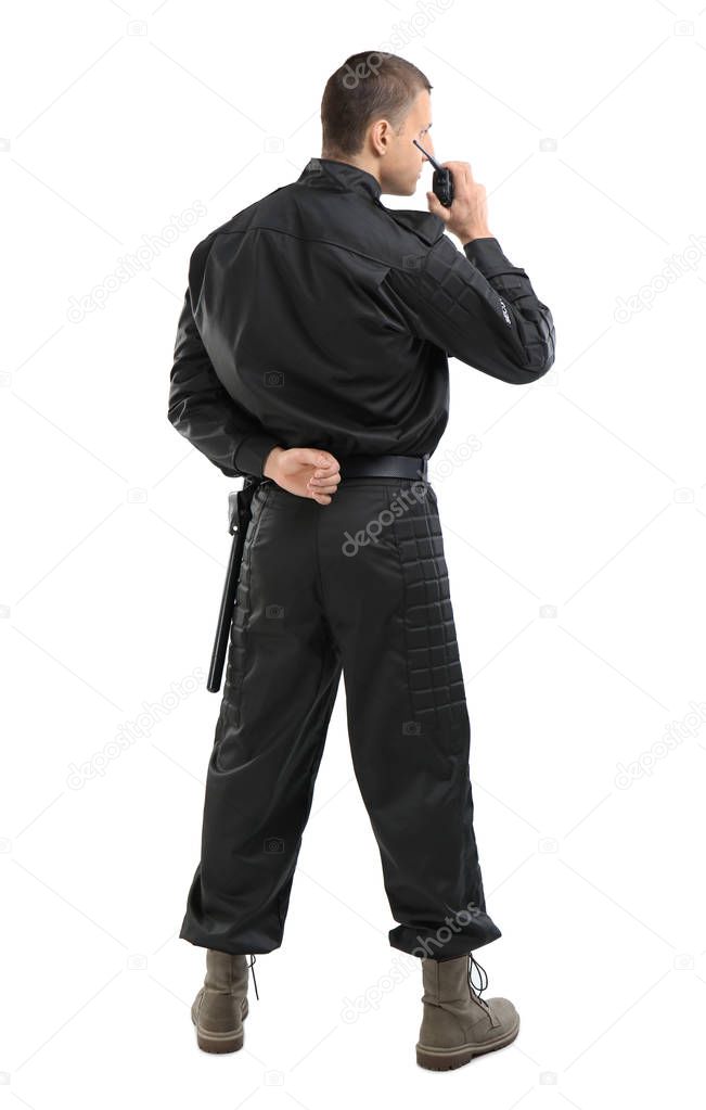 Male security guard using portable radio transmitter on color background