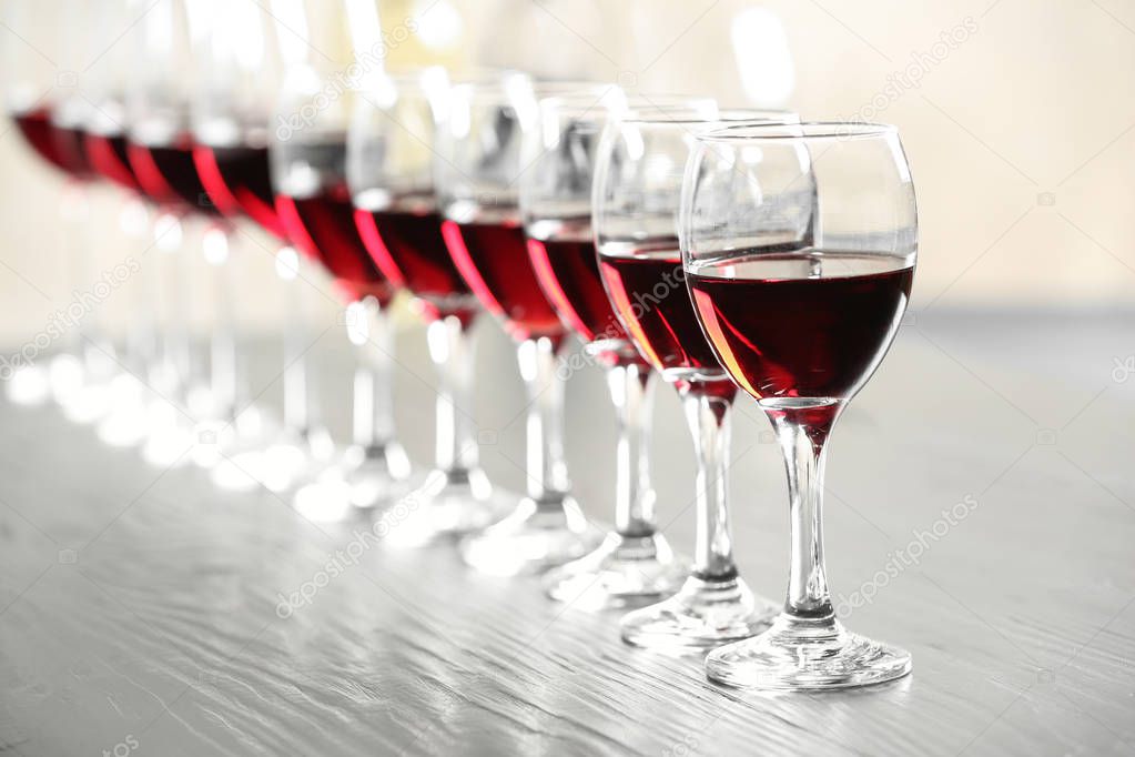 Glasses with delicious red wine on table