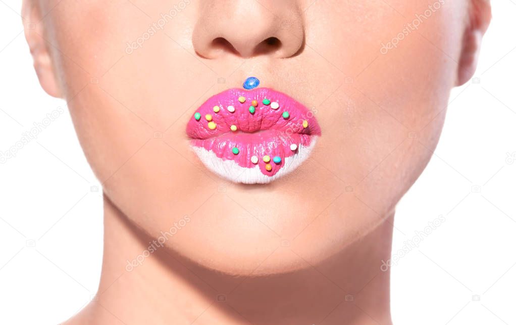 Beautiful young model with creative lips makeup on white background