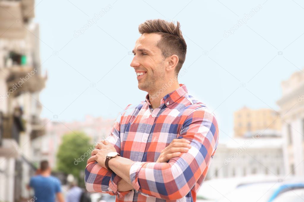 Portrait of attractive young man in stylish outfit outdoors
