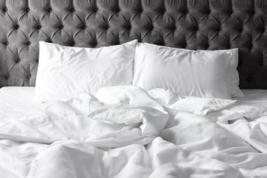 Beyaz çarşaflar ve yastıklar evde rahat yatak