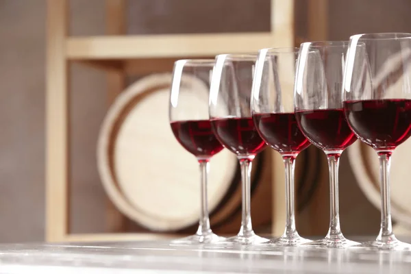 Glasses with delicious red wine on table