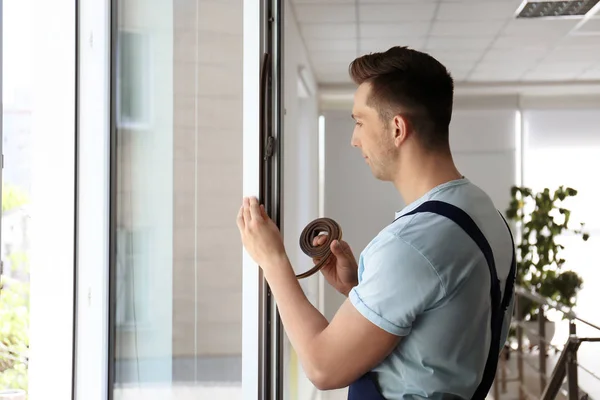 Construction Worker Putting Sealing Foam Tape Window Indoors — Stock Photo, Image