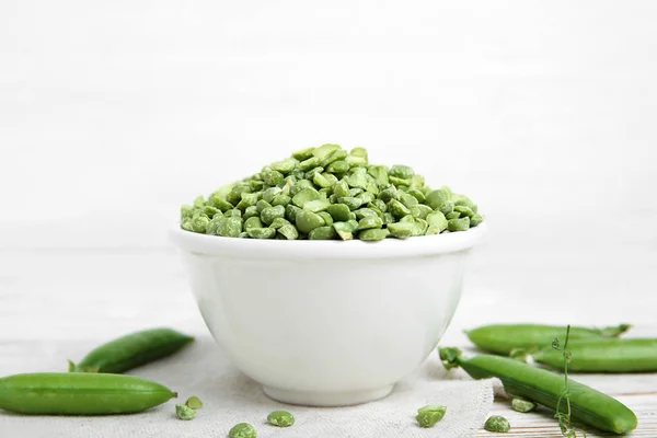 Ceramic bowl with dried peas on table