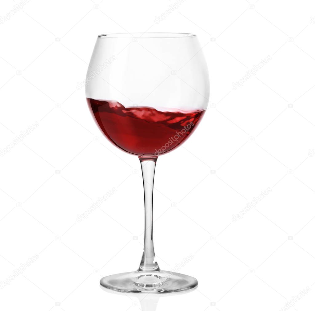 Glass with delicious red wine on white background
