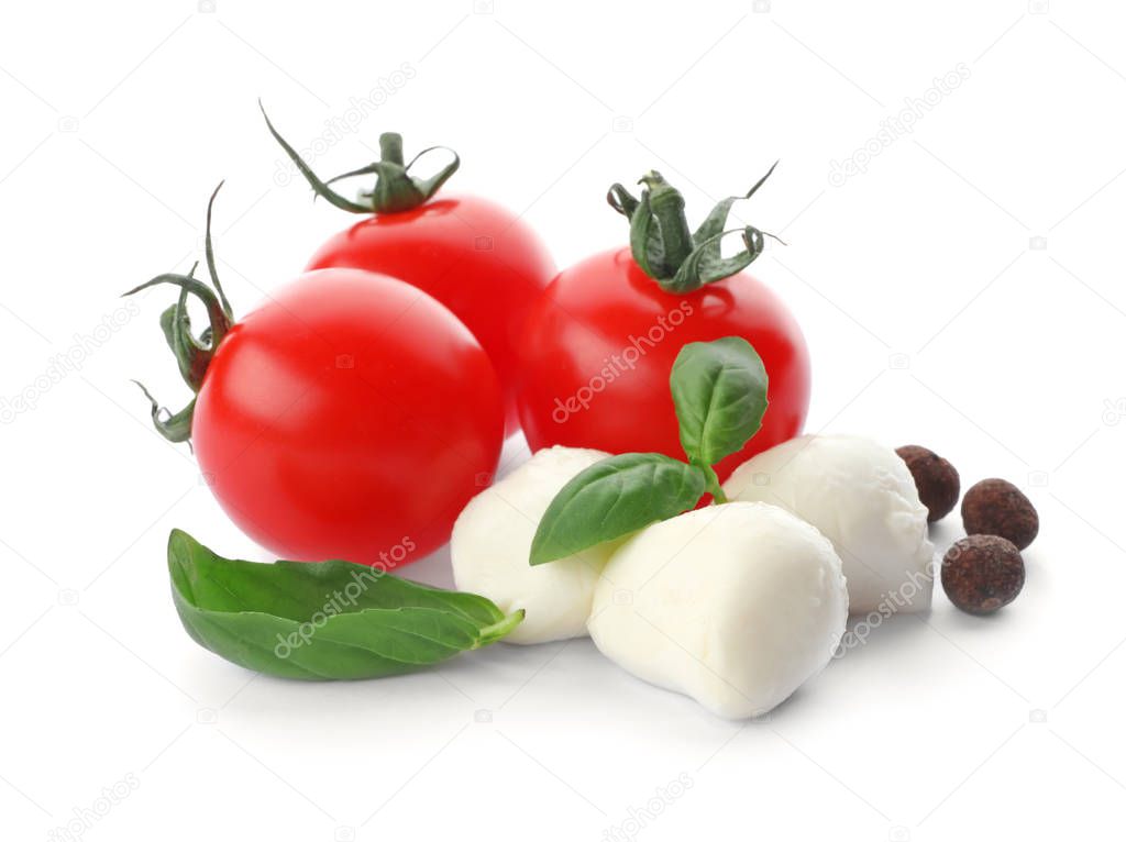 Ripe red tomatoes, mozzarella cheese balls and basil on white background