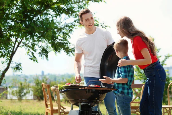 Lykkelig Familie Med Grill Med Moderne Grill Udendørs - Stock-foto