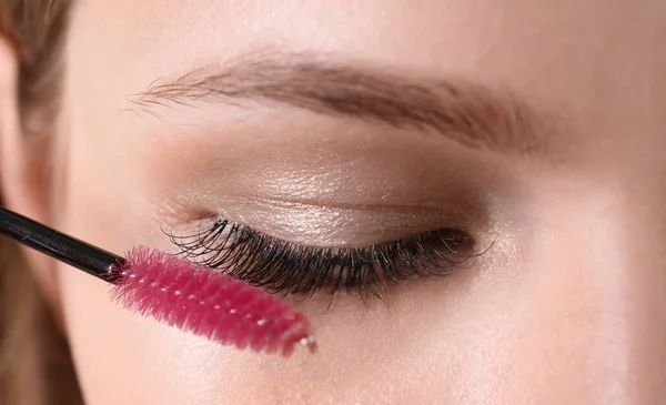 Attractive Young Woman Applying Mascara Her Eyelashes Closeup Stock Image