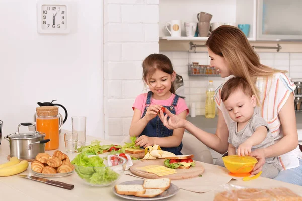 主婦は 台所に彼女の子供と夕食の準備 — ストック写真