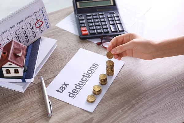 Vrouw Stapelen Munten Papier Met Zin Belastingaftrek Aan Tafel — Stockfoto